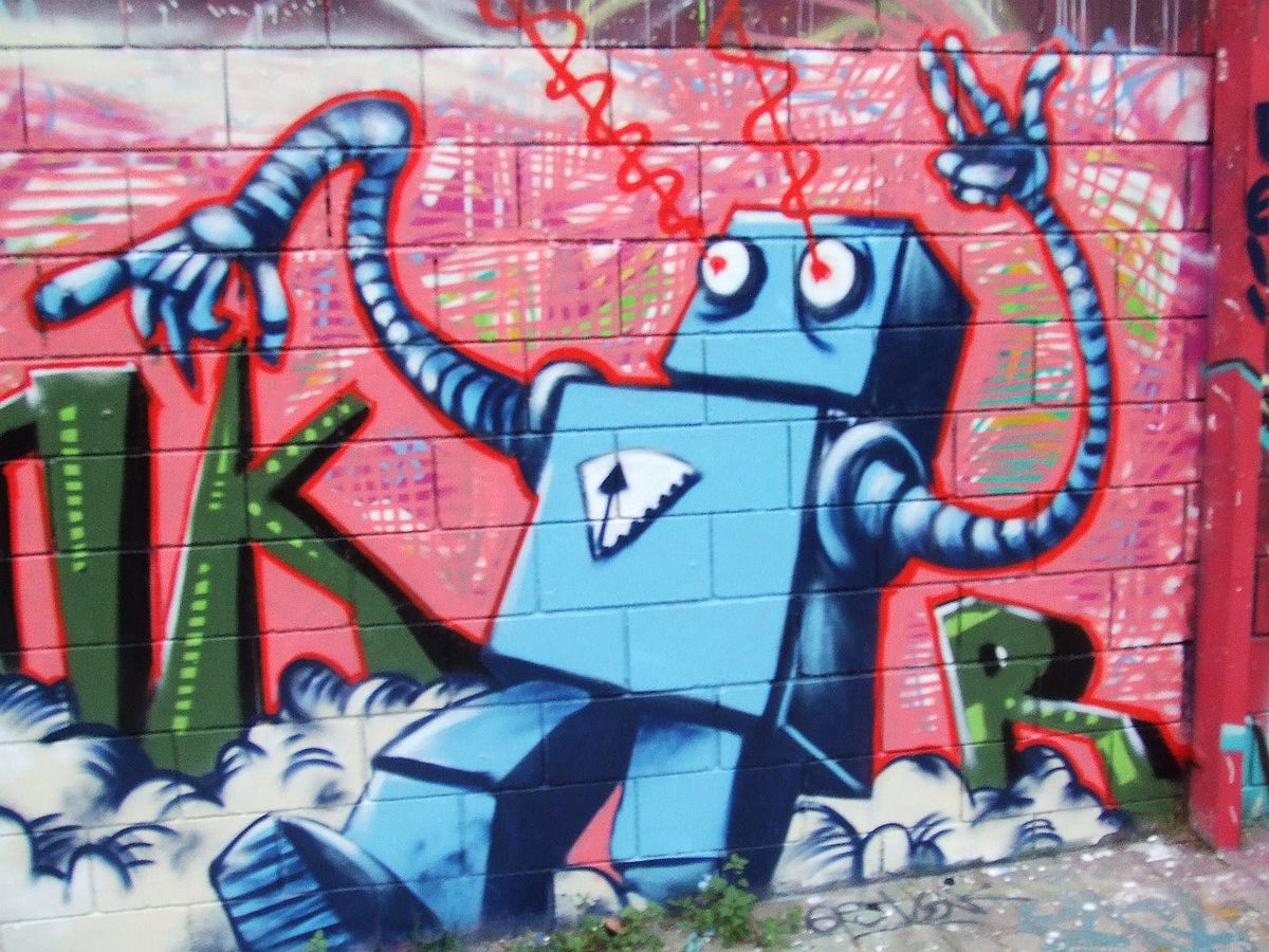 Street-art robot, a little unhinged, holding on